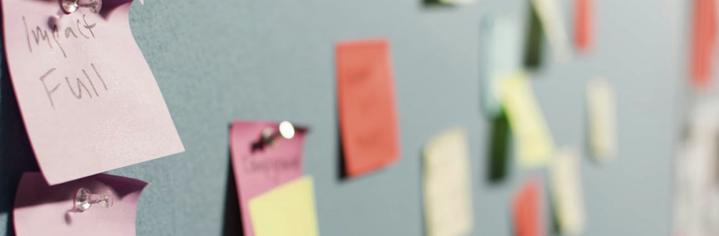Post it notes on a bulletin board.