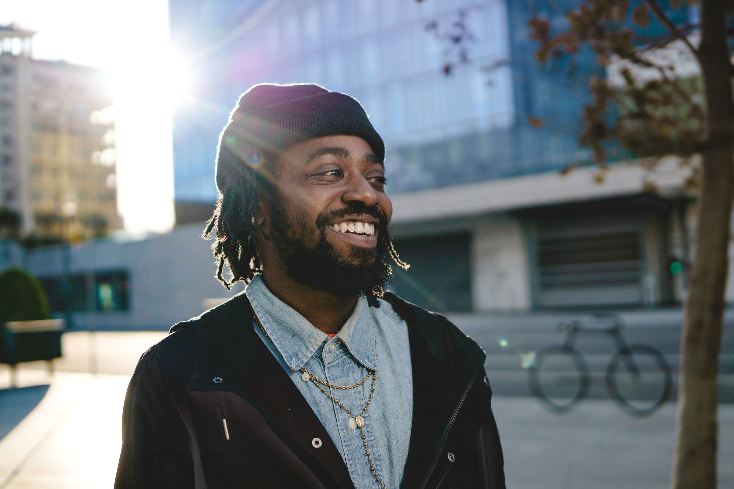 Man walking down the street and smiling.